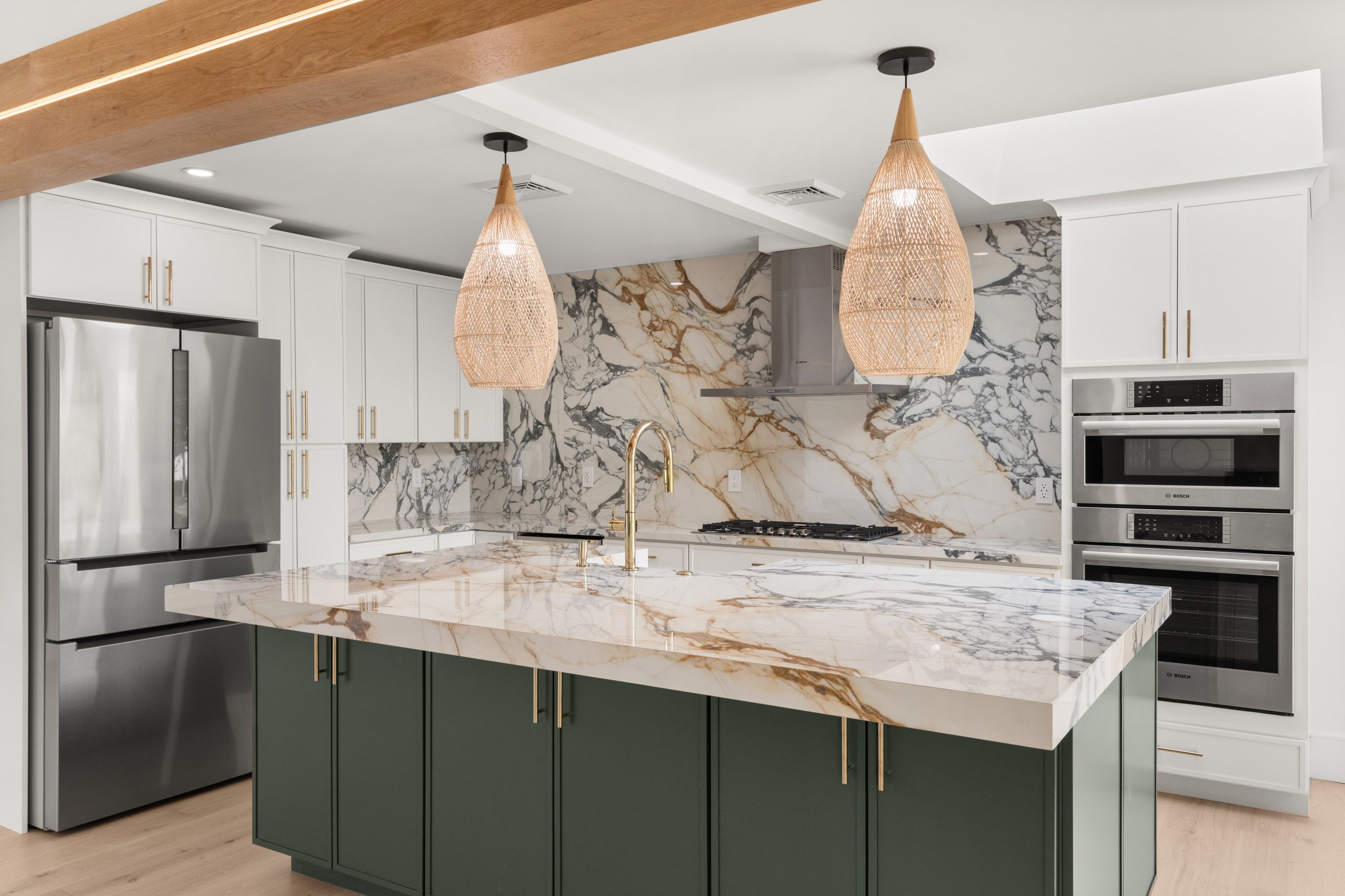 Custom kitchen with marble island and brass fixtures